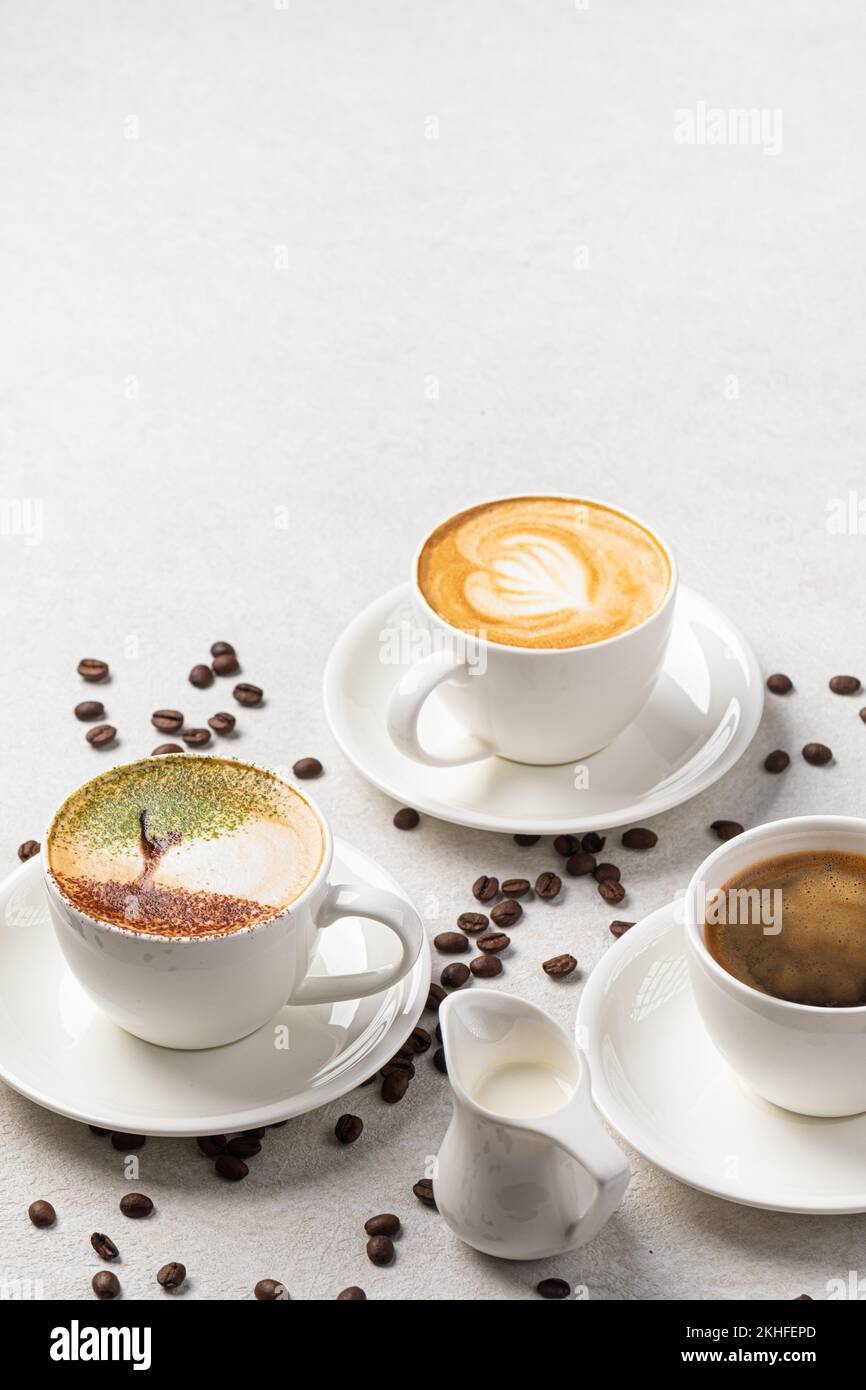 Assorted cups of coffee on the white background Stock Photo