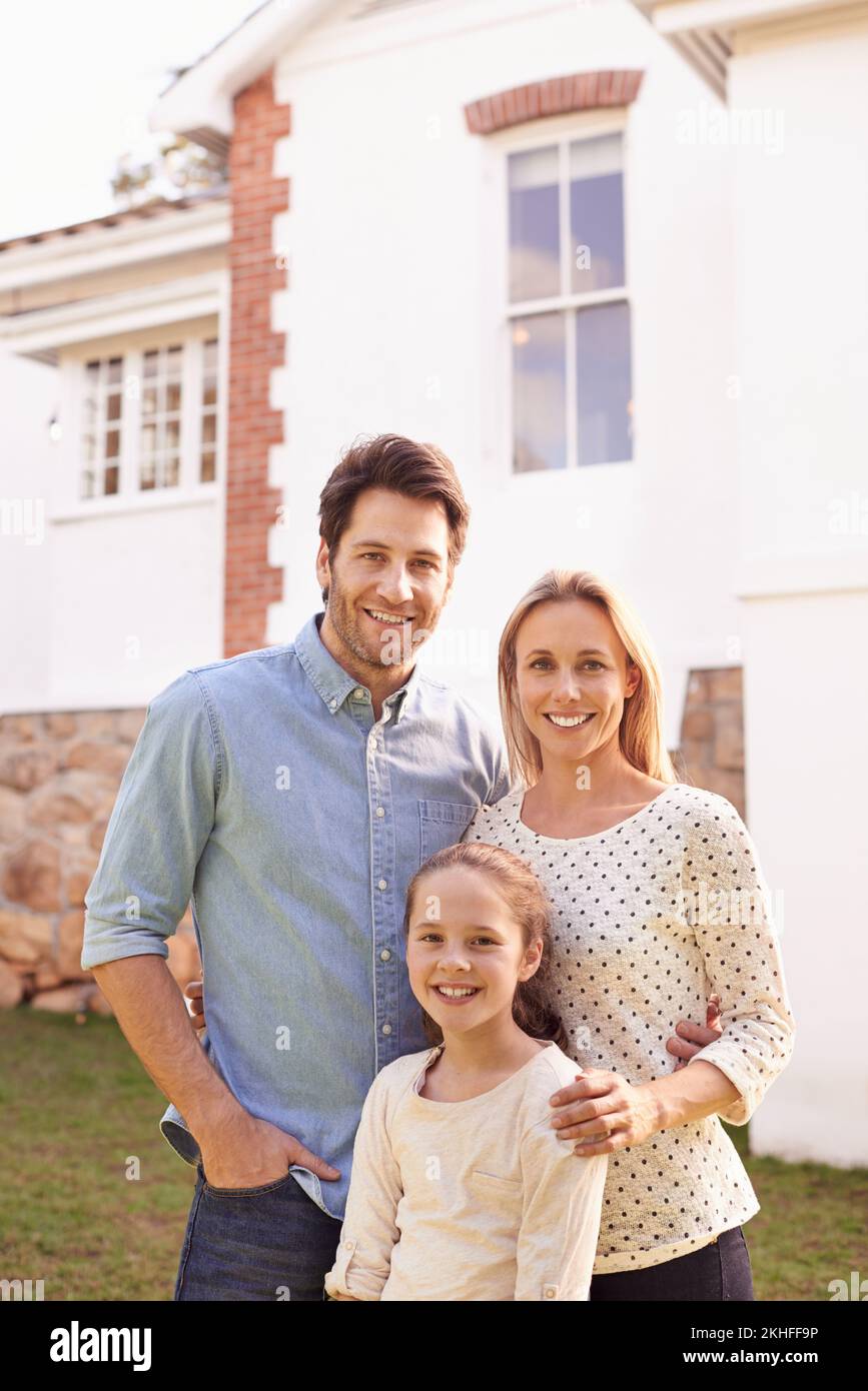 Our beautiful new home. A portrait of a happy family posing outside their home. Stock Photo