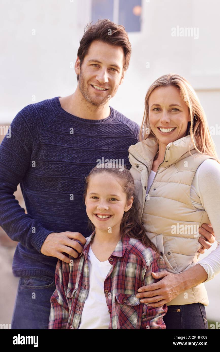 Portrait of happiness. A portrait of a happy family posing outside their home. Stock Photo