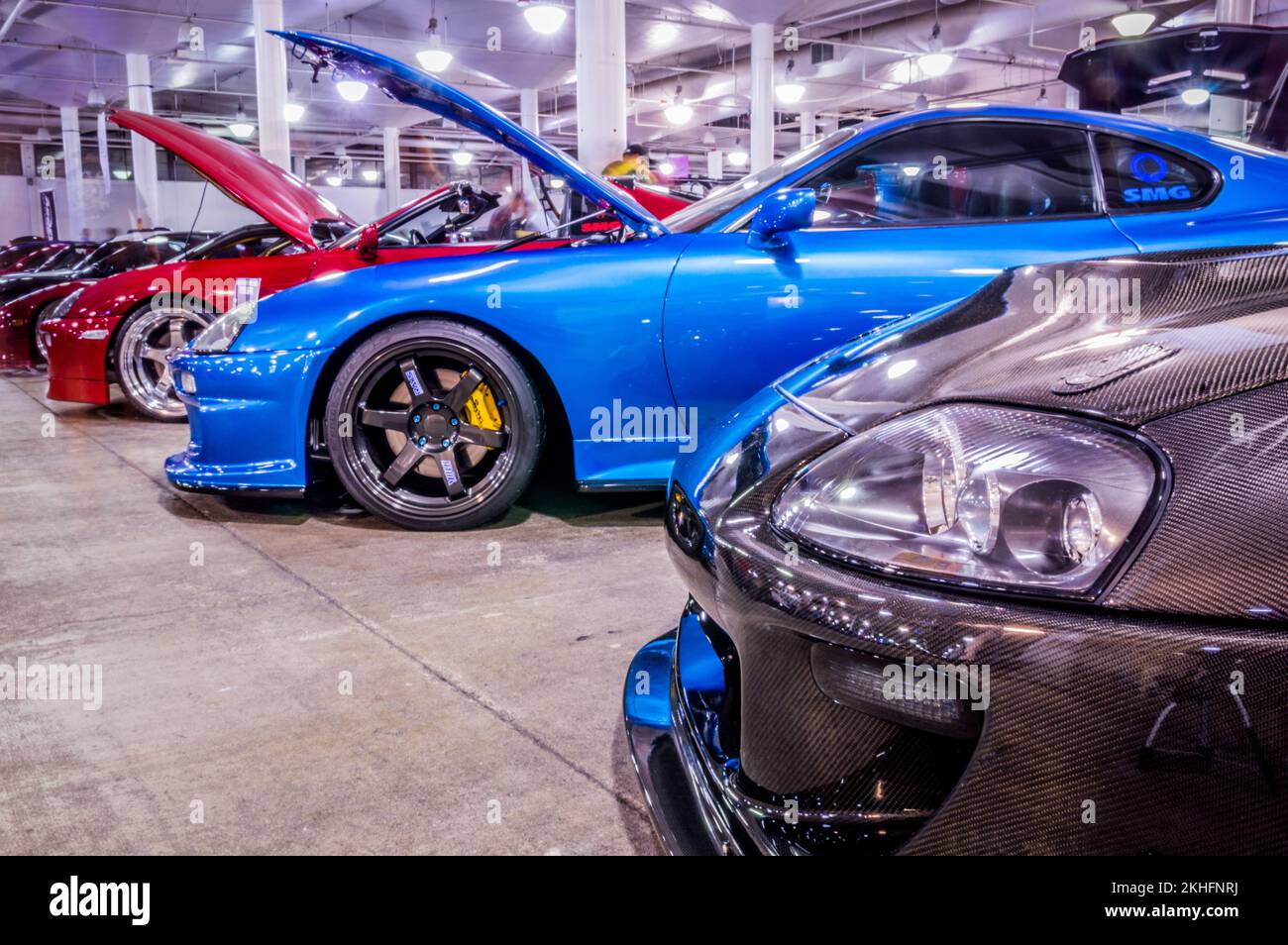The cars in a row with open hoods at Hot Import Car Show in Honolulu ...