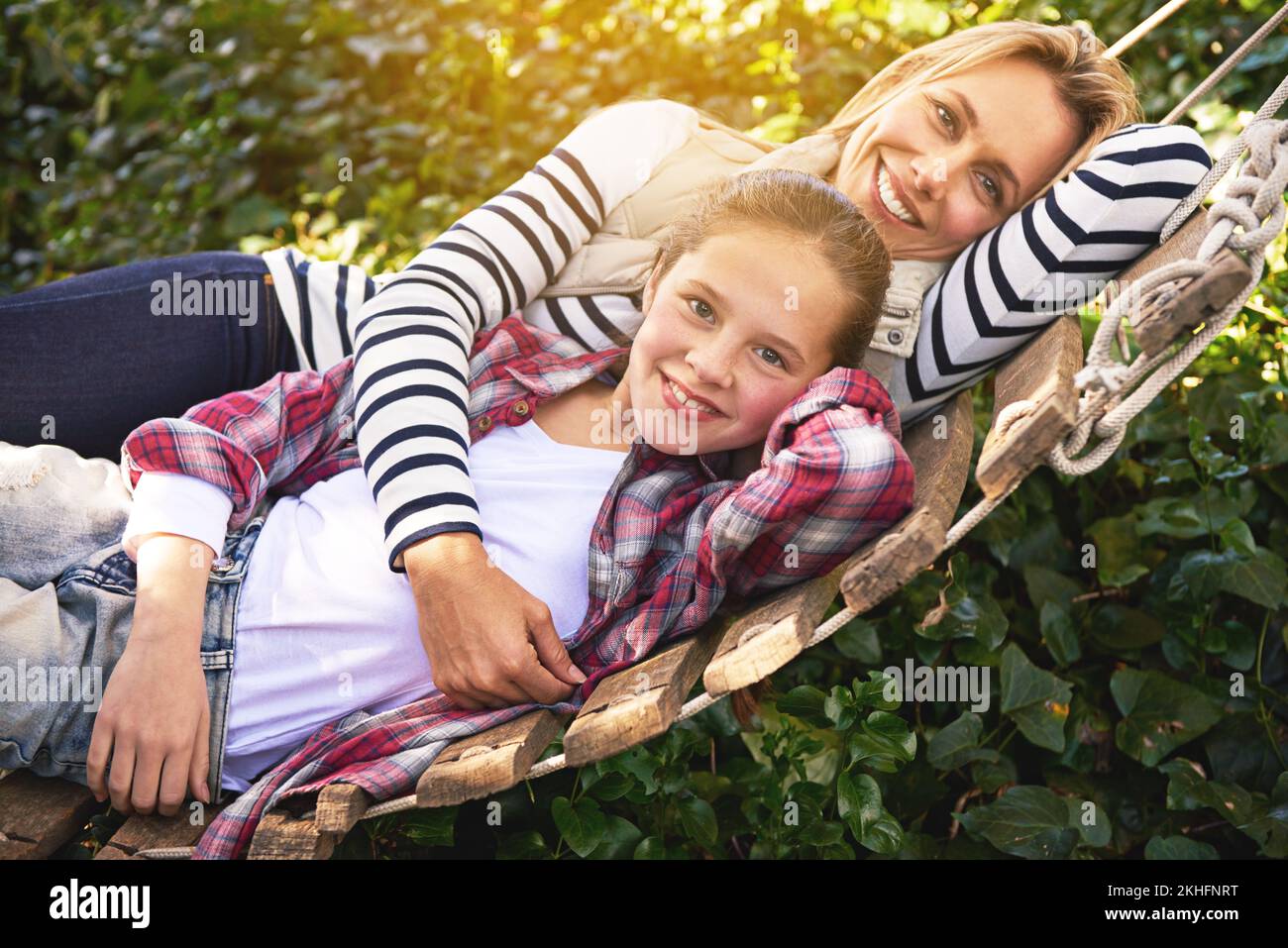 Our time together is priceless. A mother and daughter lying on a hammock together in the garden. Stock Photo