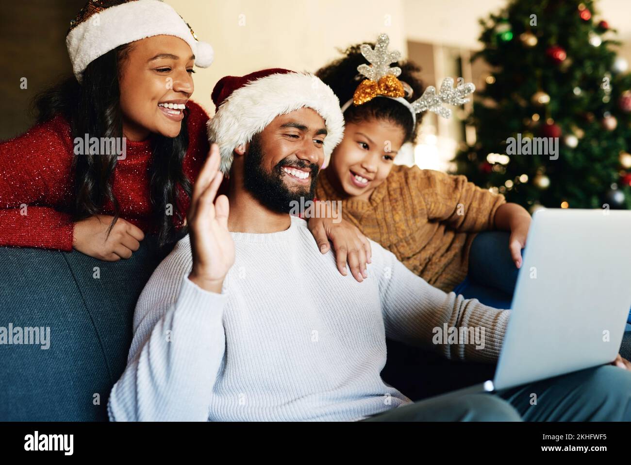 Christmas, video call and laptop with family in living room for communication, connectivity and celebration. Internet, technology and online with Stock Photo