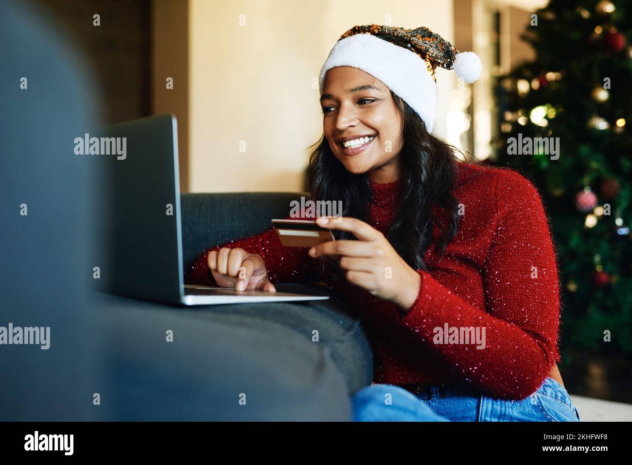 Online shopping, Christmas and woman with credit card and laptop for banking on the internet from home. Finance, ecommerce and girl shopping for xmas Stock Photo