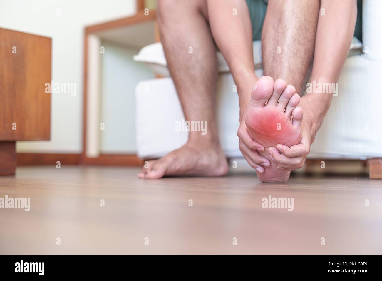 man having barefoot pain due to Plantar fasciitis and  bunion toes or blister due to wearing narrow shoes and waking or running longtime. Health and m Stock Photo