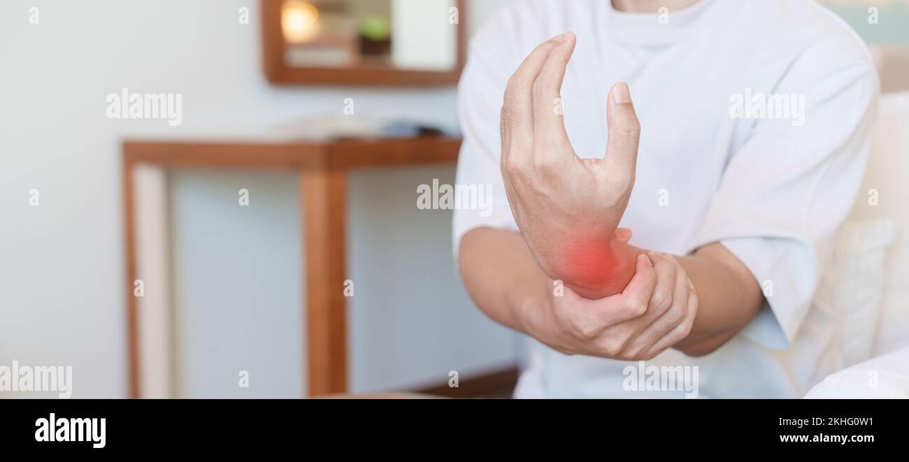 man having wrist pain because using smartphone or computer long time. De Quervain s