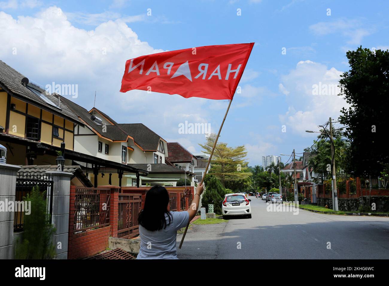 A supporter waves a flag of Pakatan Harapan in Kajang, Malaysia November 24, 2022. REUTERS/Lai Seng Sin Stock Photo