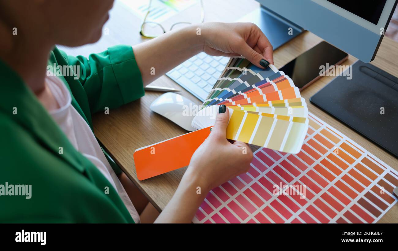 Female interior designer working with fan of colourful samples Stock Photo