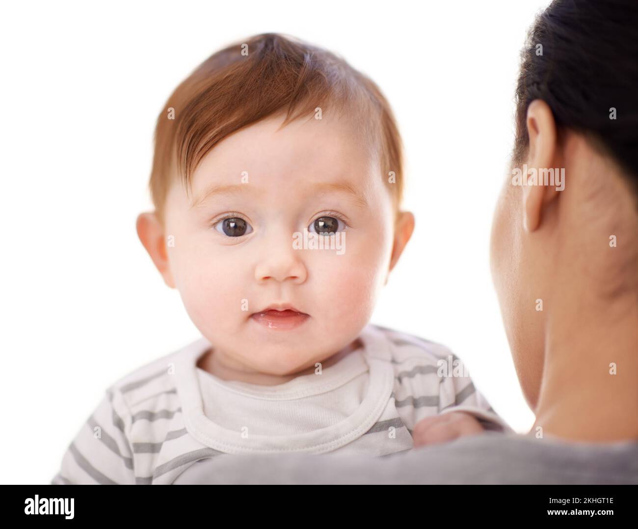 Hello there. Portrait of a little baby girl being held by her mother. Stock Photo