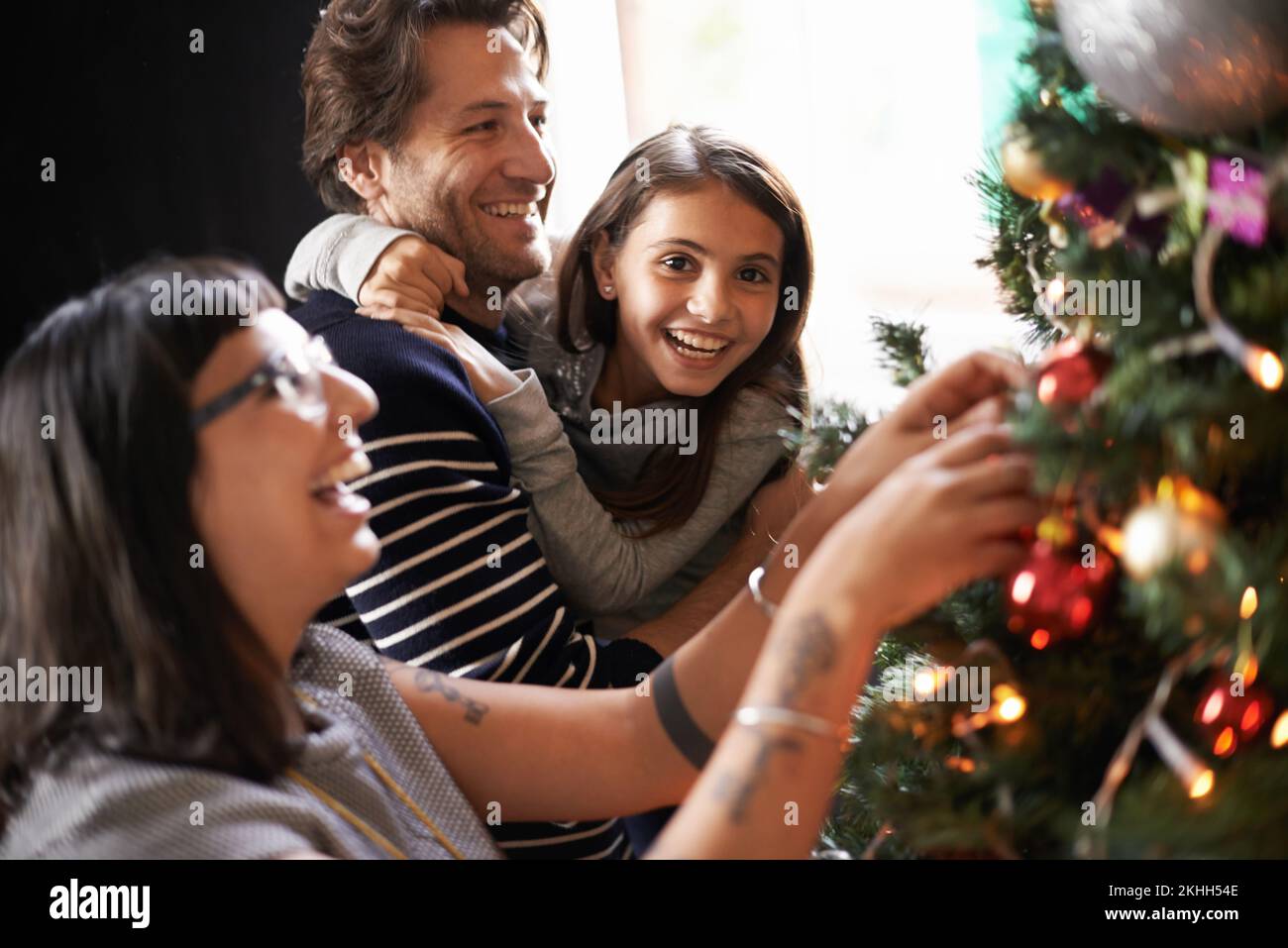 Oh mom youre no good at this. family laughing at their poor decorating skills. Stock Photo