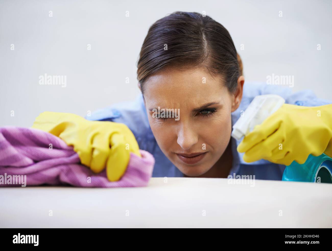 You will be removed you stubborn stain. woman struggling to remove a