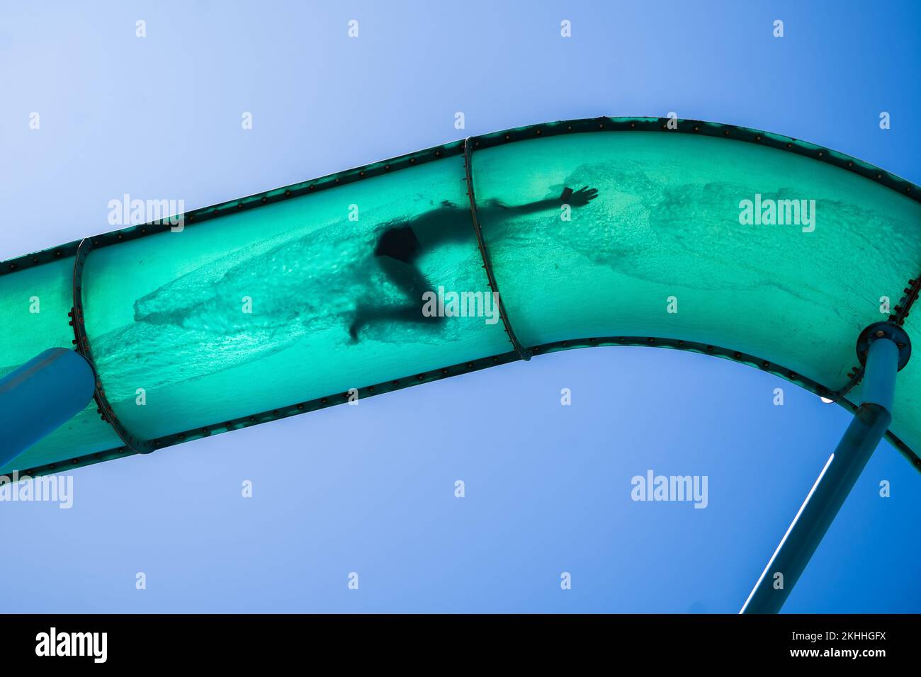 Adelaide, Australia. 24 November 2022.  A human figure silhouetted in a waterslide tube in the coastal suburb of Glenelg, Adelaide as people take advantage of the warm sunshine with temperatures forecast to climb to 31celsius in Adelaide and South Australia. Credit: amer ghazzal/Alamy Live News Stock Photo