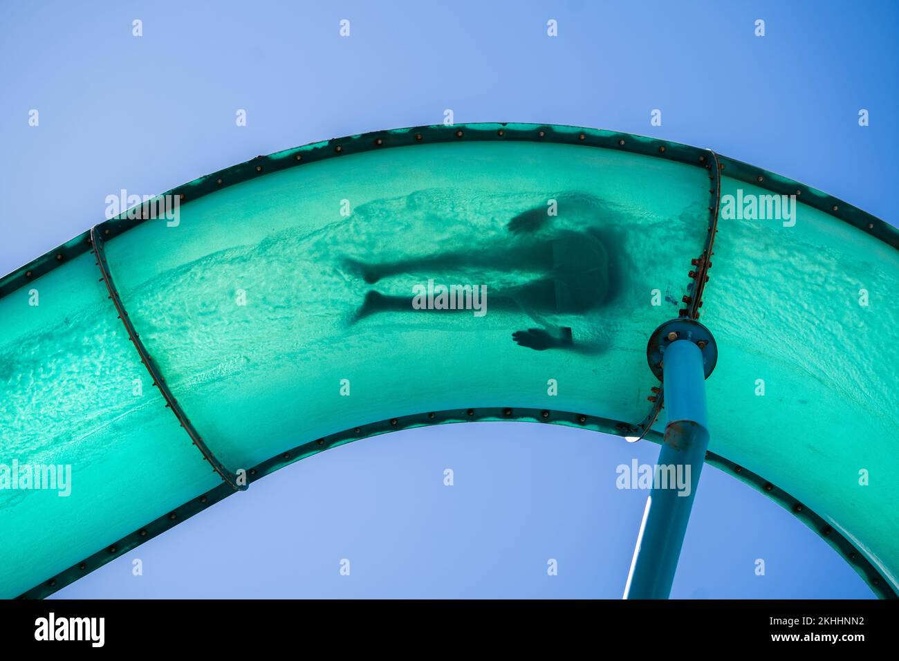 Adelaide, Australia. 24 November 2022.  A human figure silhouetted in a waterslide tube in the coastal suburb of Glenelg, Adelaide as people take advantage of the warm sunshine with temperatures forecast to climb to 31celsius in Adelaide and South Australia. Credit: amer ghazzal/Alamy Live News Stock Photo