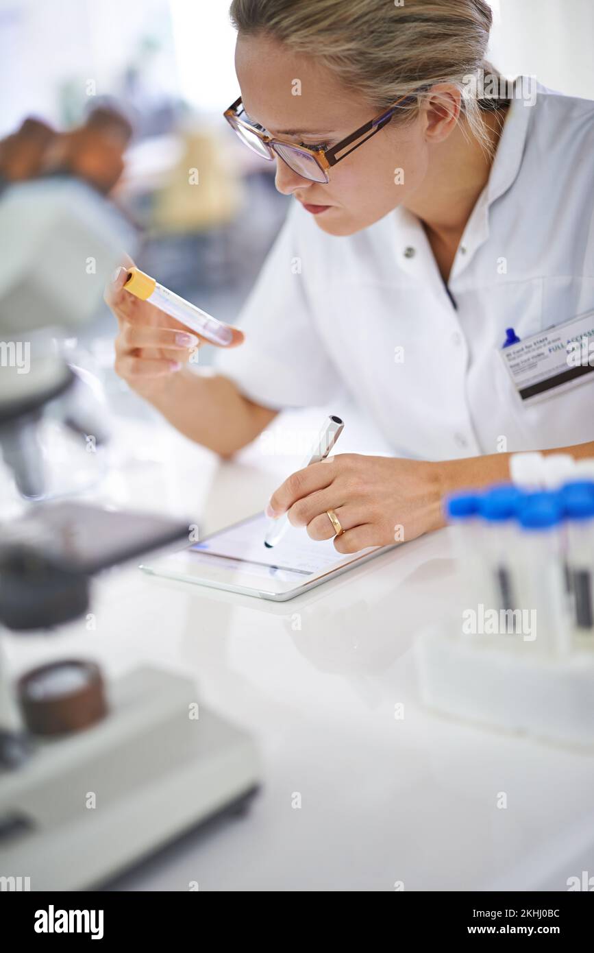 Hmm...this is an interesting development. an attractive young female scientist working in her lab. Stock Photo