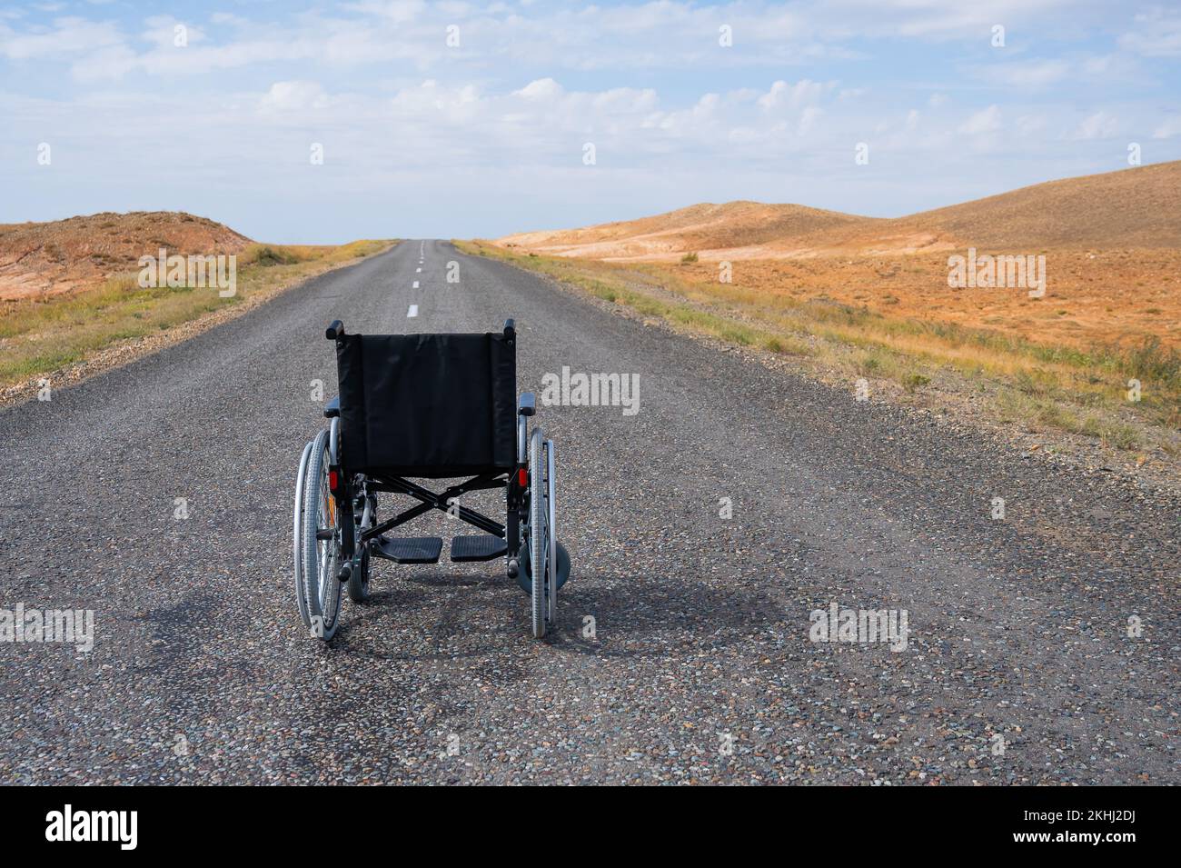 Empty wheelchair on the highway in the steppes Stock Photo Alamy