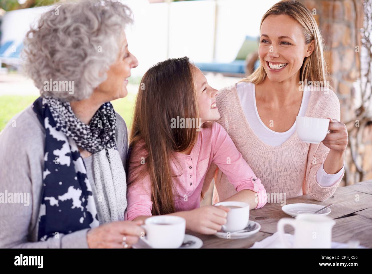 These girls love their tea. three generations of the woman of the women of a family having tea outside. Stock Photo