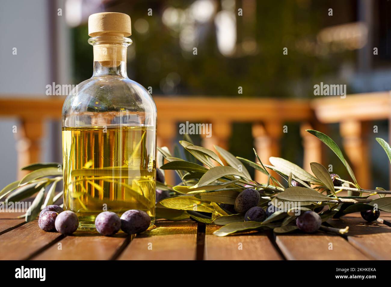 Olive oil with olive tree branch background. Natural oil for food or cosmetics from natural ingredients. Healthy food, cosmetics concept. High quality photo Stock Photo