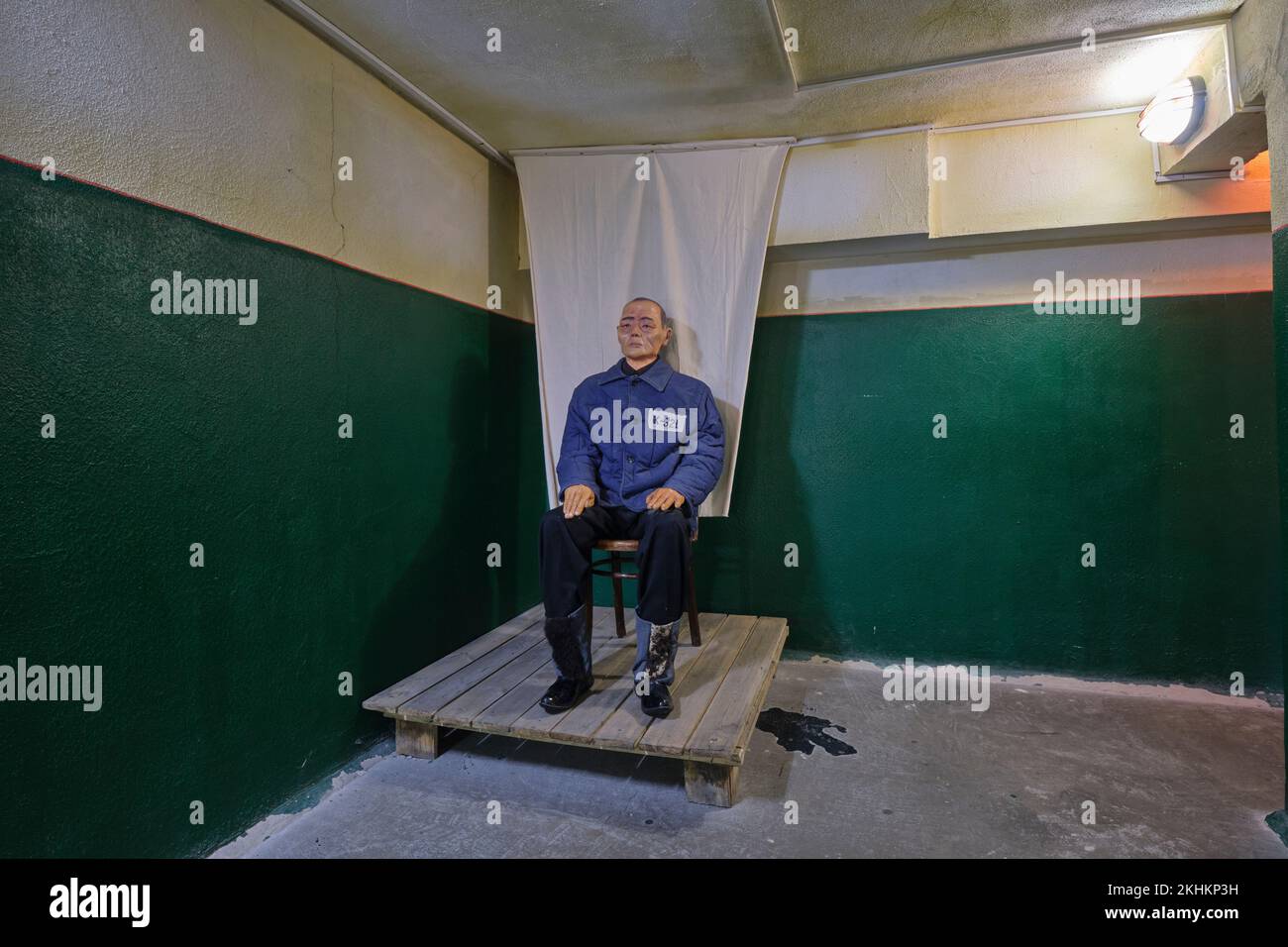 Recreation of a prisoner, worker sitting, posing for an identification photograph at the work, labor camp, gulag. At the Museum For The Victims Of Pol Stock Photo
