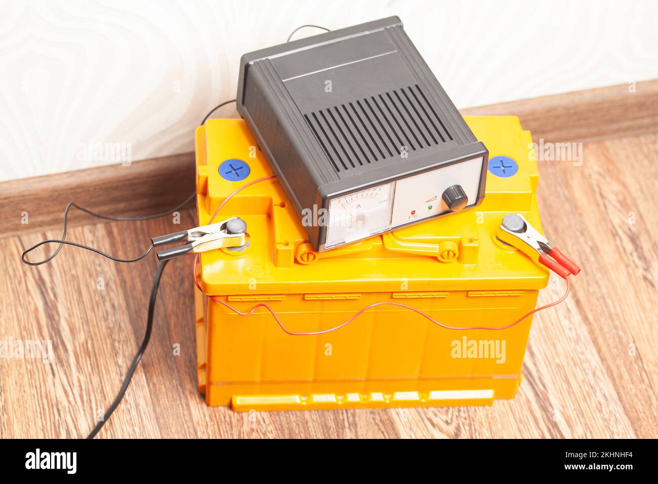 yellow car battery with car battery charger Stock Photo Alamy