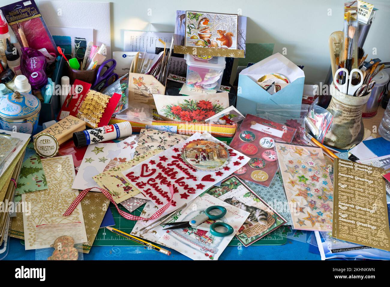 Messy Christmas card crafting table Stock Photo
