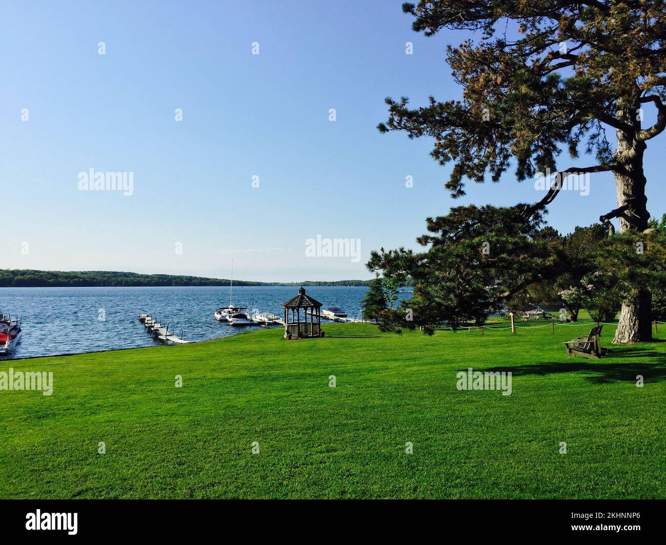 The shoreline of Skaneateles lake with anchored boats, surrounded by