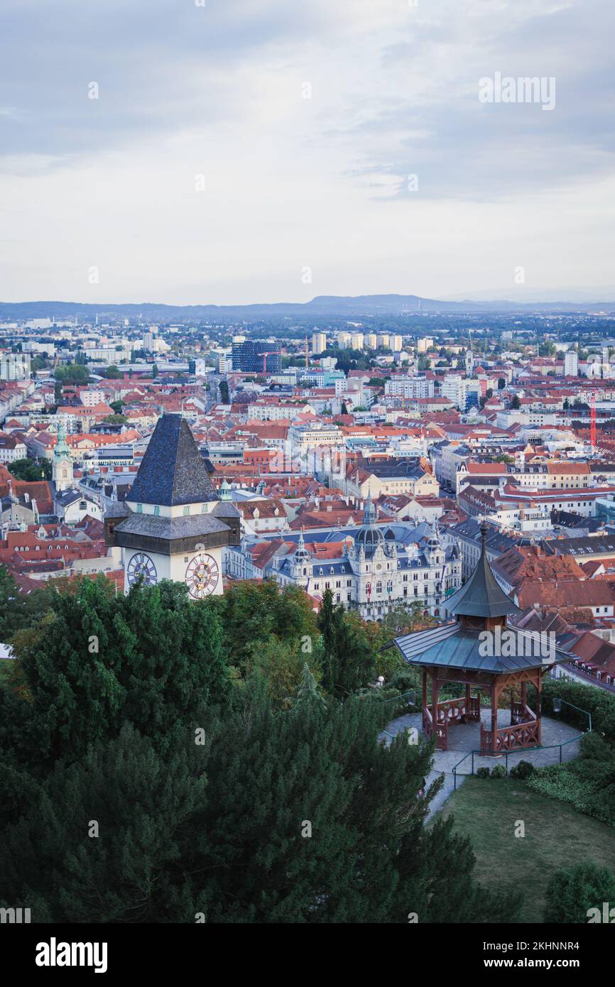 A vertical of the beautiful cityscape of Graz with a display of Uhrturm ...