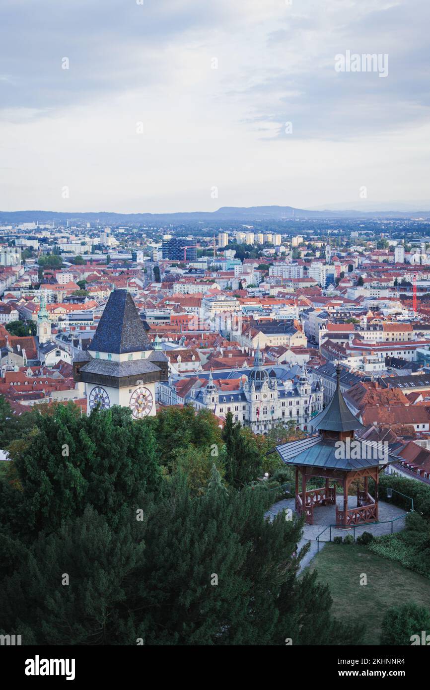 A vertical of the beautiful cityscape of Graz with a display of Uhrturm Clock tower in Austria Stock Photo
