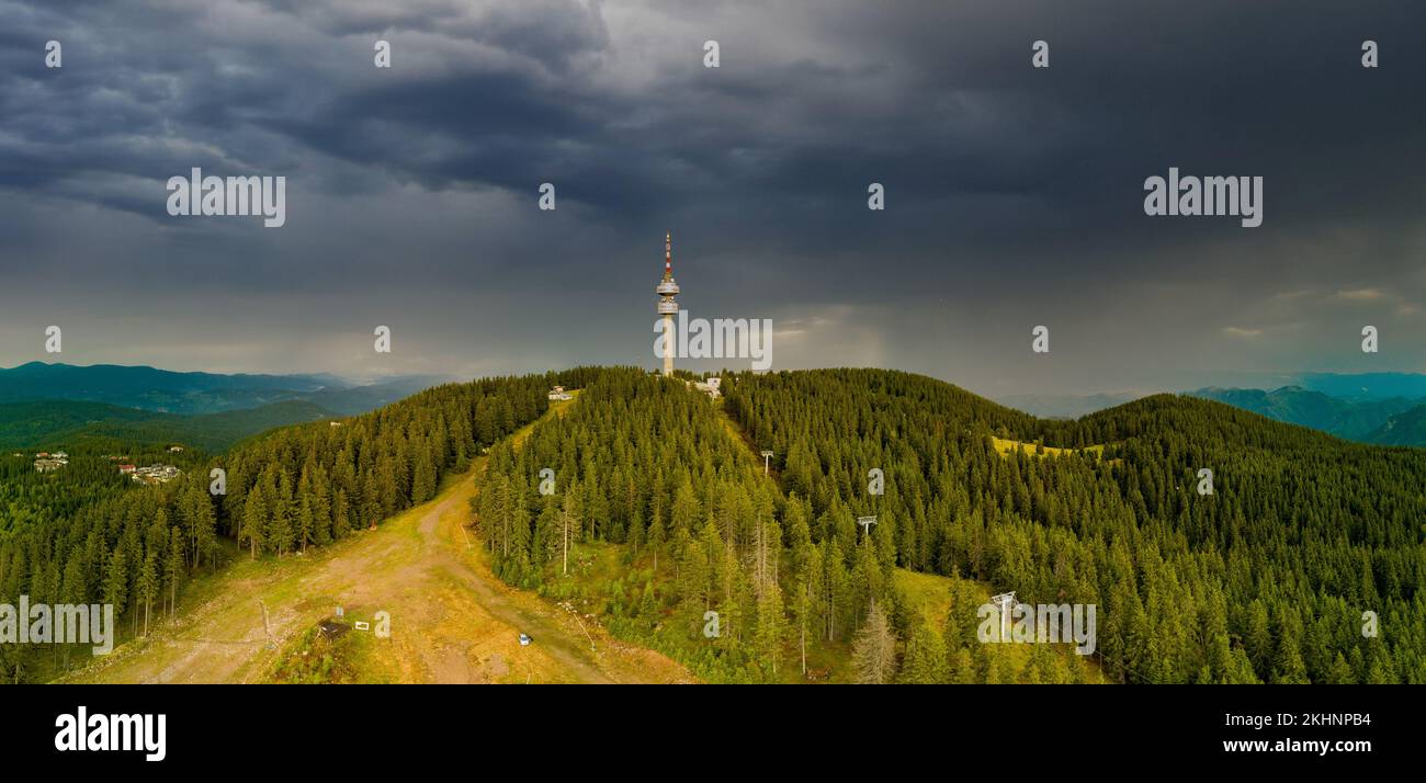 Snezhanka tower in valley of Rhodope mountains and forests against clouds. Panorama, top view Stock Photo