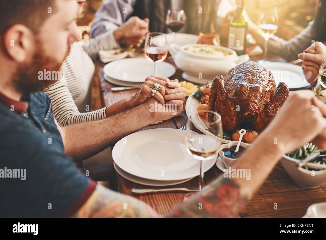 Chicken, prayer and family holding hands praying for food to God or Jesus on a Christmas holiday party at home. Trust, peace and Christian people in Stock Photo