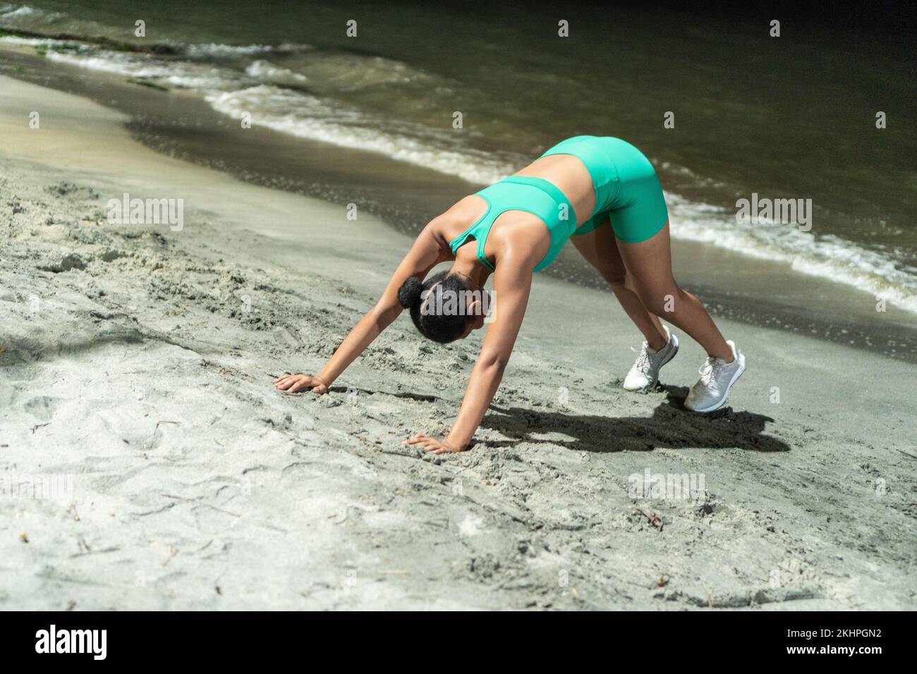 Black Sportswoman Doing Push Ups On Beach Stock Photo
