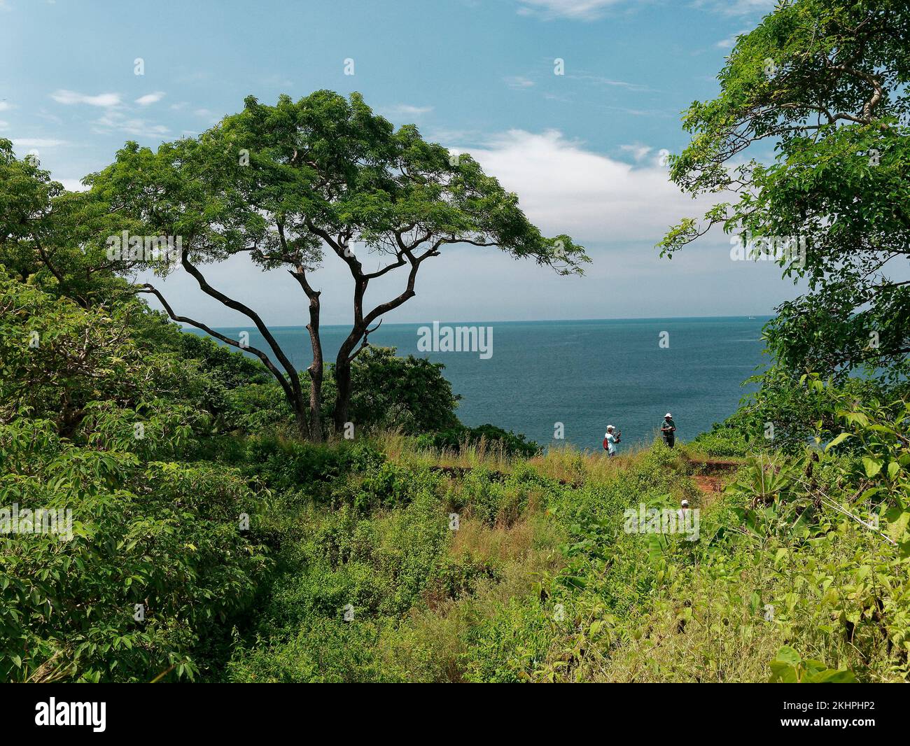 Tourist taking photo of ruins of Cabo de Rama Fort and Arabian Sea in Goa India 10 14 2022 Stock Photo