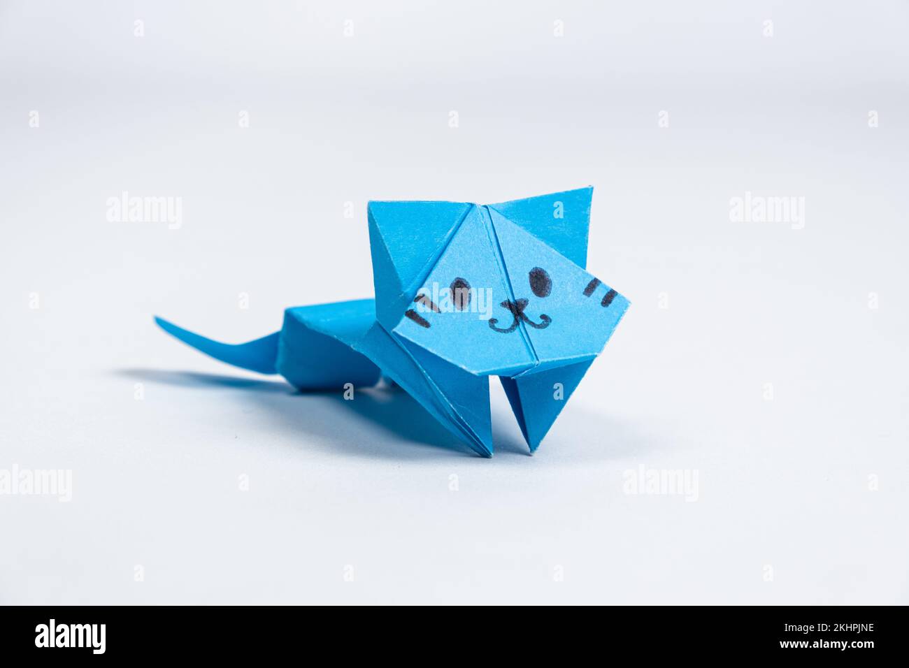 Blue origami paper cat, crafts for children and adults, DIY animal figurines, white background