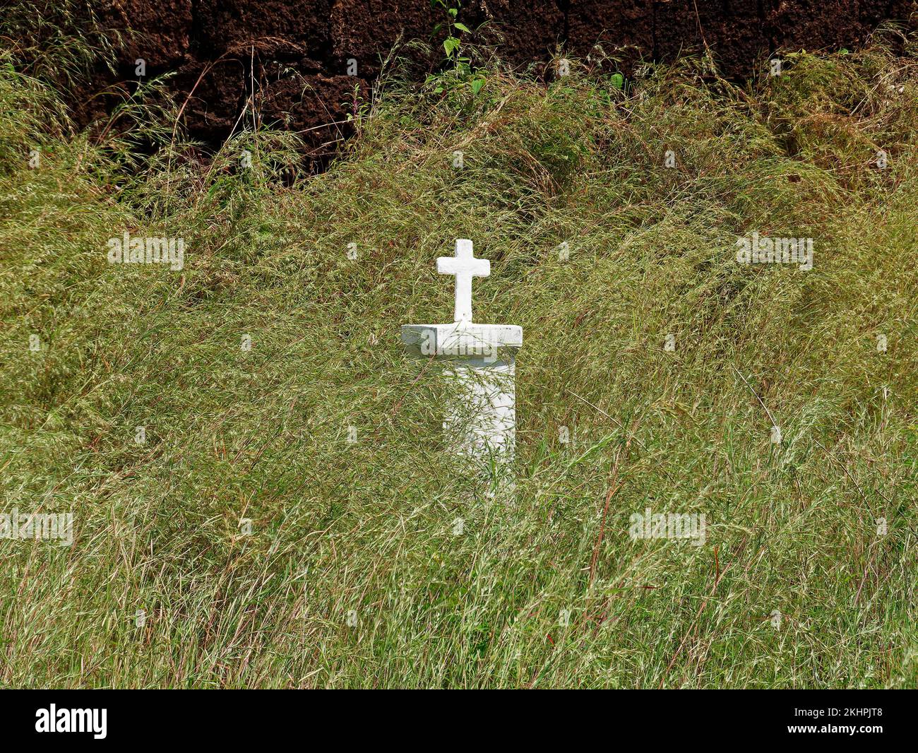 Religious Cross stand in wild green grass at Cabo de Rama Fort in Goa India 10 14 2022 Stock Photo