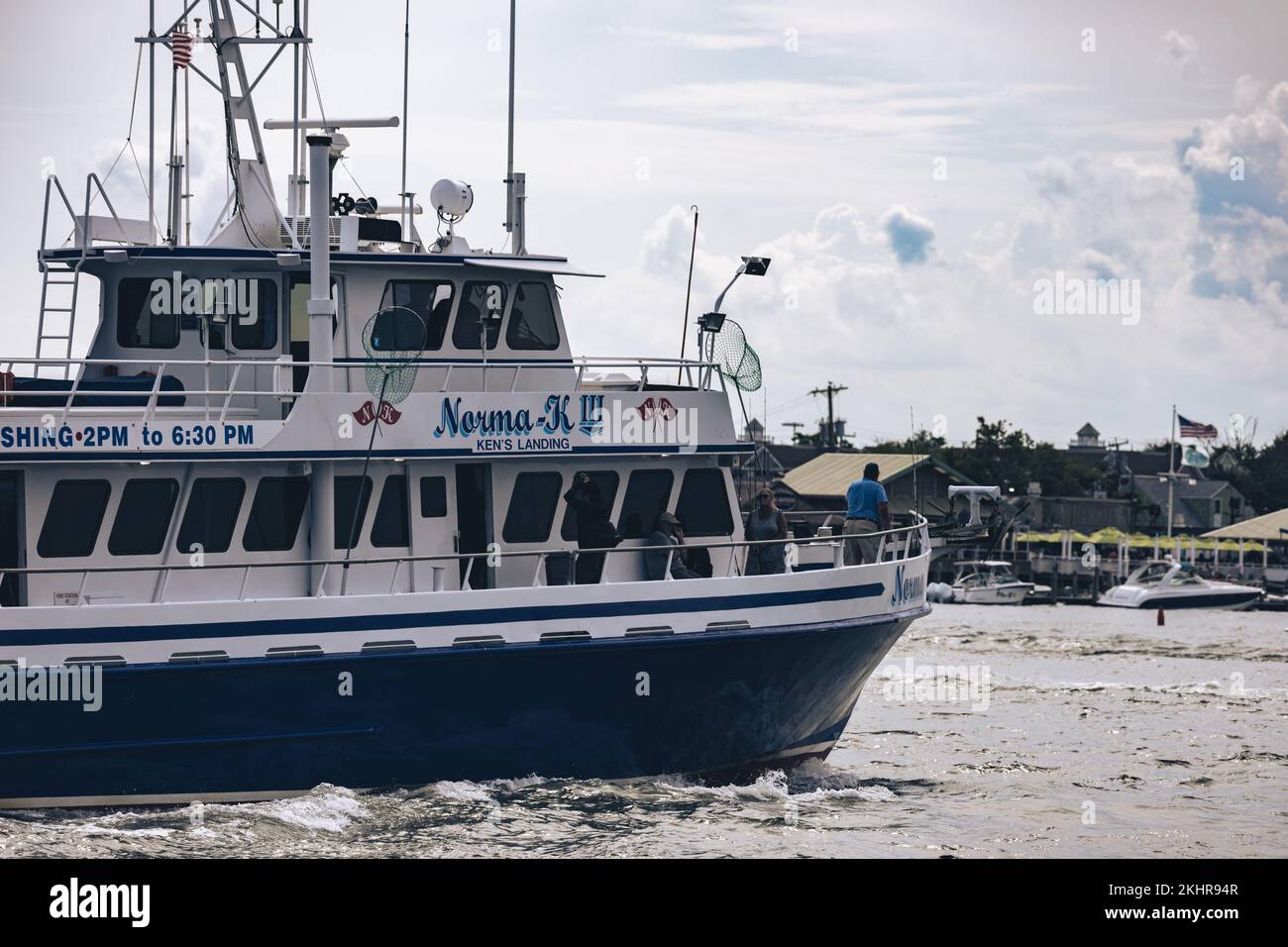 A fishing boat entering an inlet in Manasquan, New Jersey Stock Photo