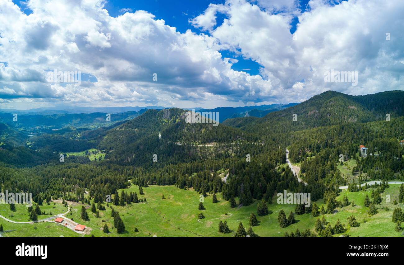 Valley of Balkan mountains with fog, sunny clouds and forests. Village ...