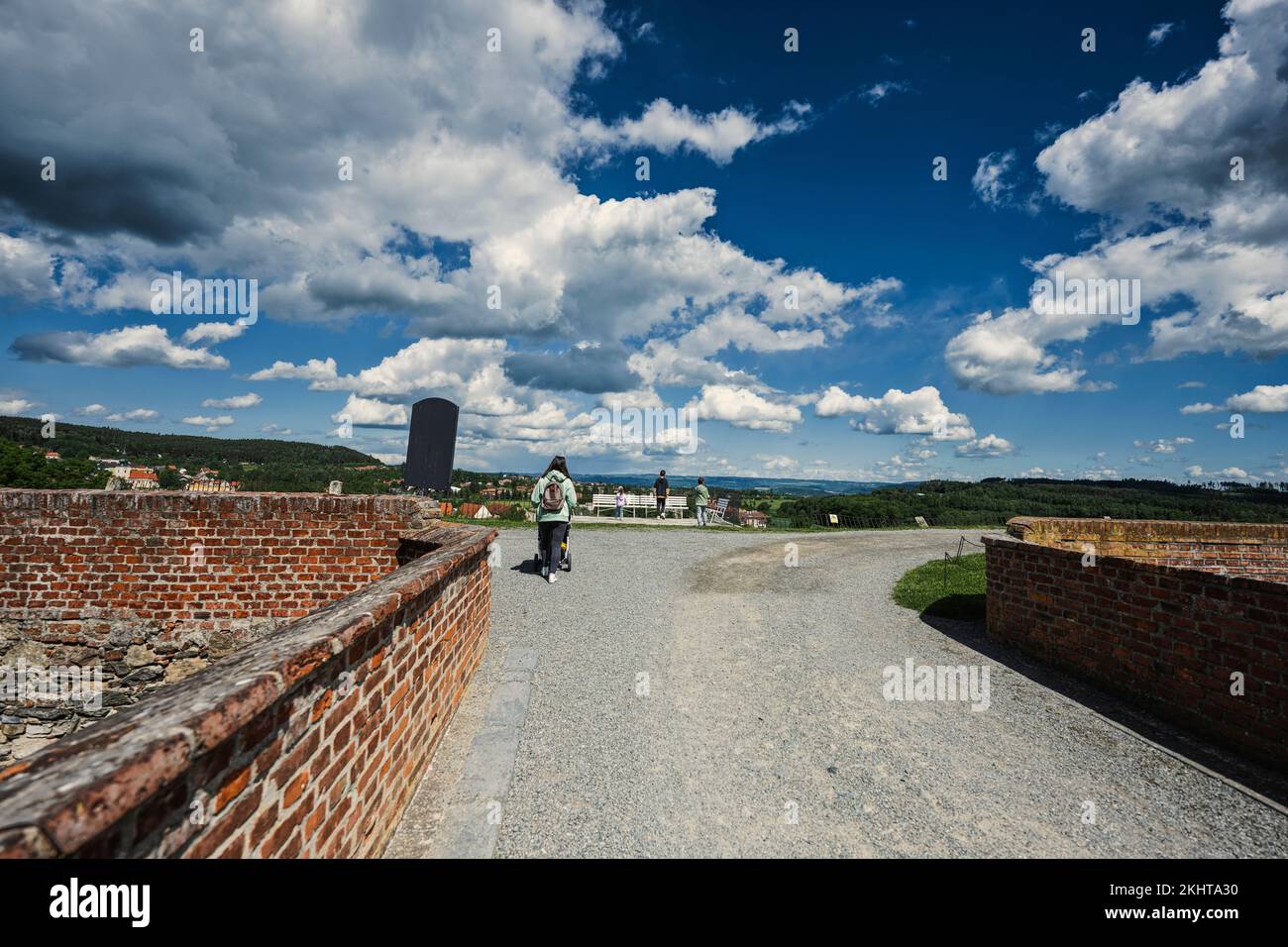 Back of mother with children walking at Chateau Kunstat, Czech Republic. Stock Photo