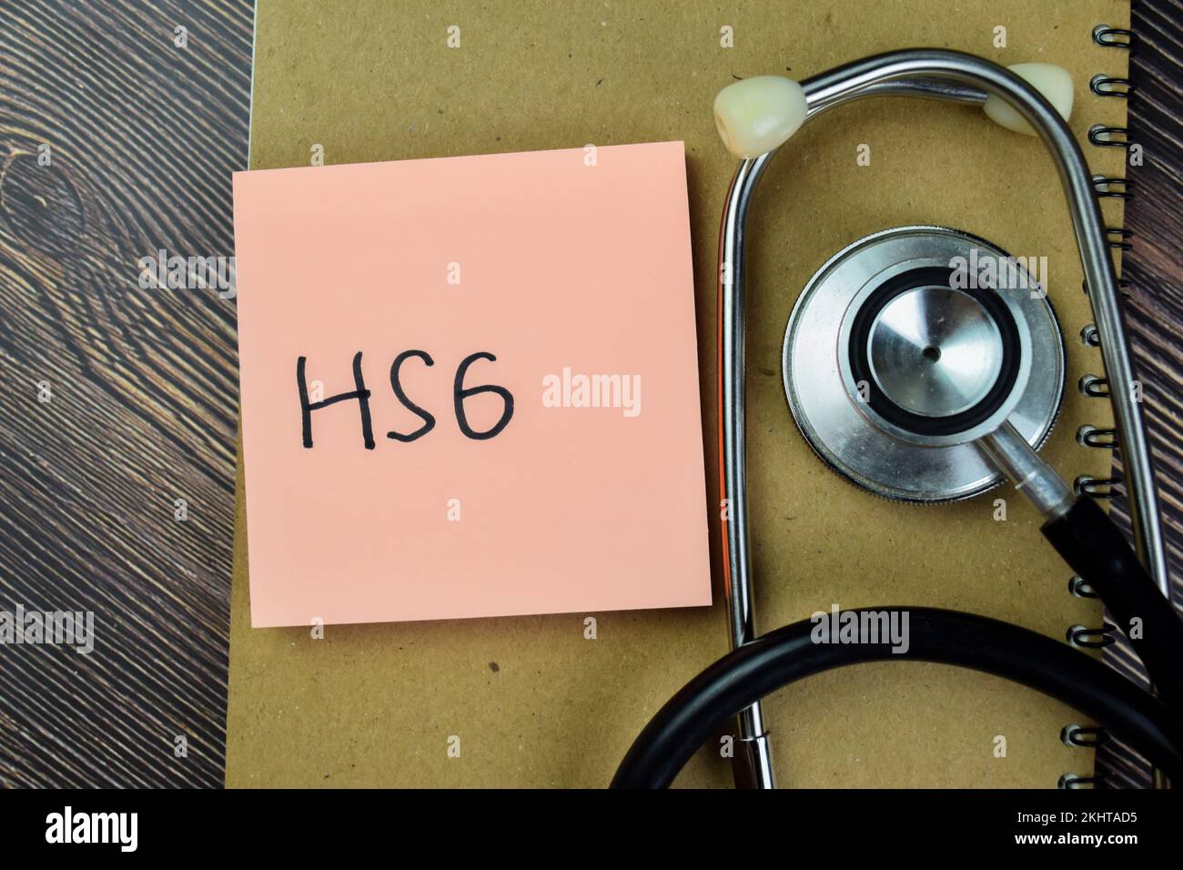 Concept of HSG write on sticky notes with stethoscope isolated on Wooden Table. Stock Photo