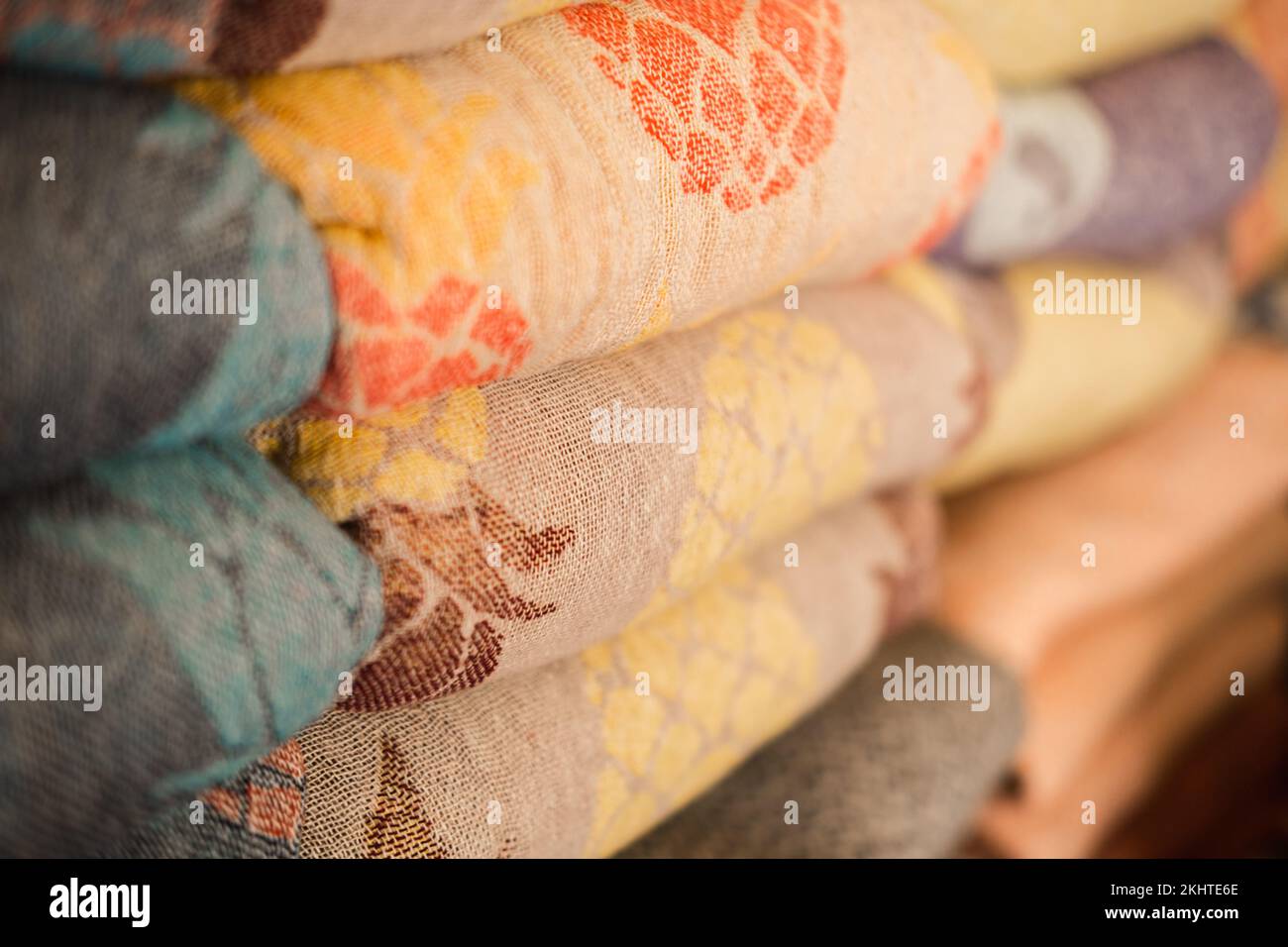 Samples of linen fabrics in a pile on store shelf. Stock Photo