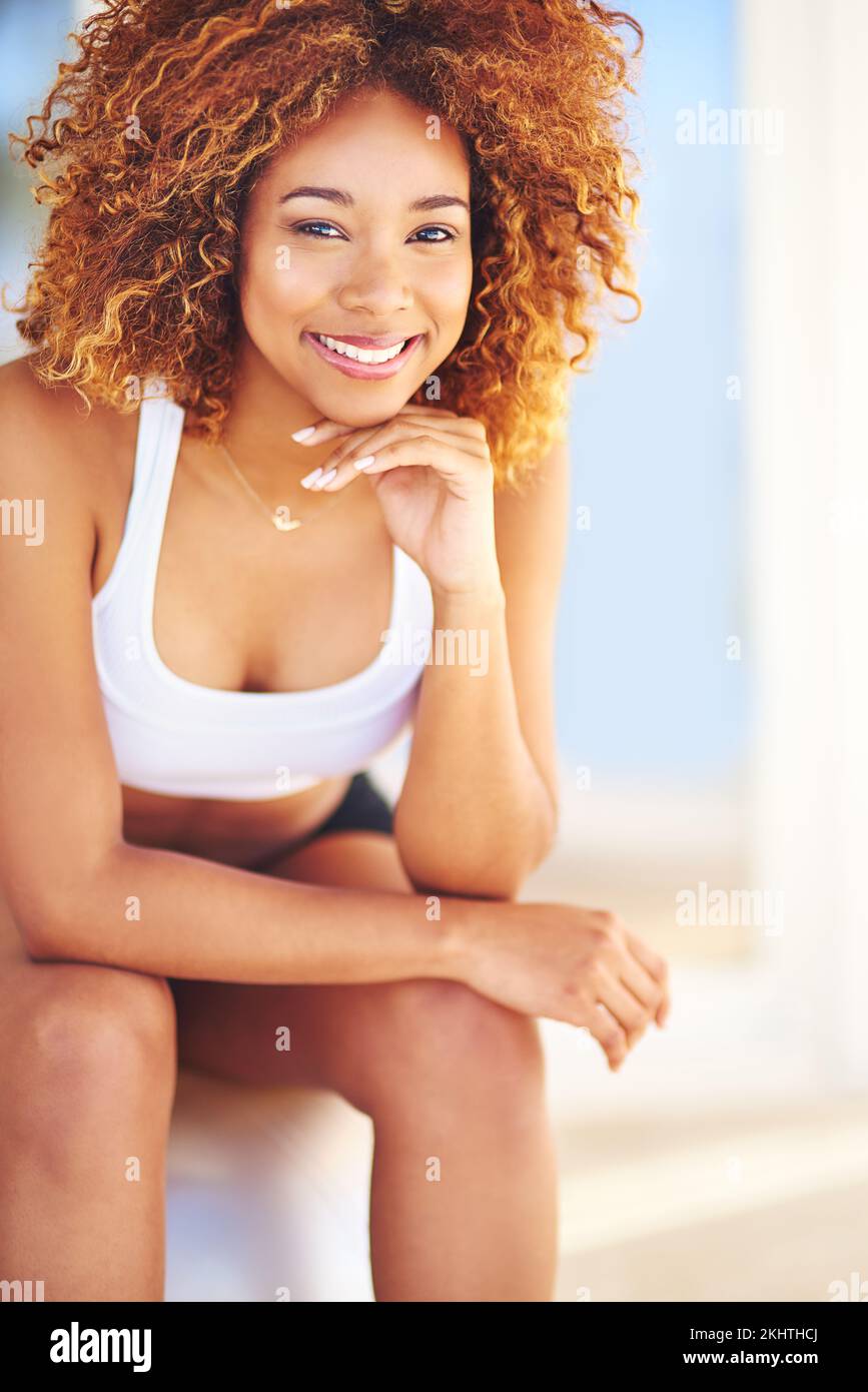 Black woman, fitness and sitting on exercise ball for body workout, sport training and pilates. Yoga, physio wellness motivation and african woman on Stock Photo