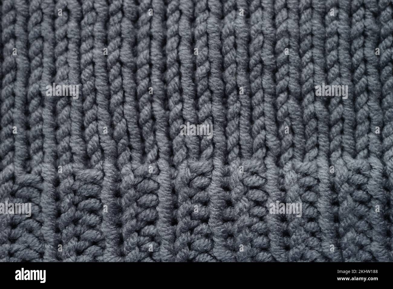 Knitted grey background, gray sweater cozy pattern. Stock Photo