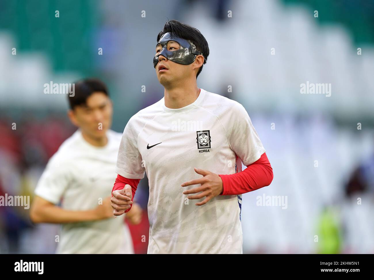 South Korea's Son Heung-min warms up sporting a face mask ahead of the FIFA World Cup Group H match at the Education City Stadium, Doha, Qatar. Picture date: Thursday November 24, 2022. Stock Photo