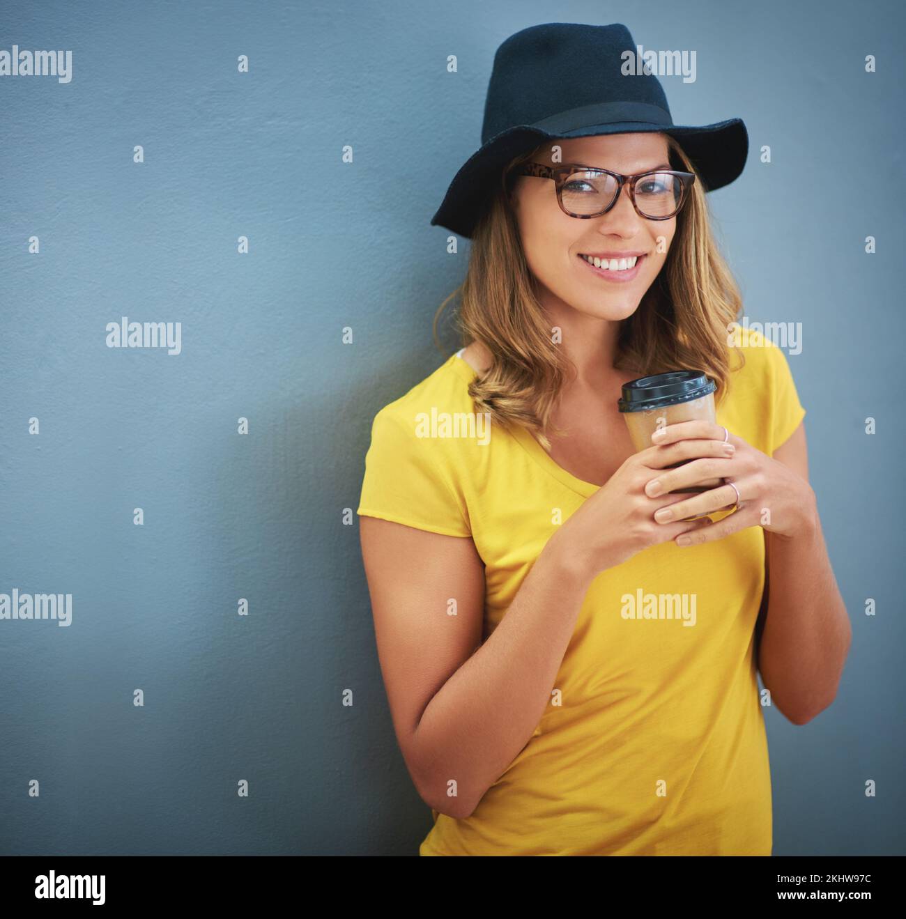 Fashion, glasses and woman with coffee on wall with cappuccino