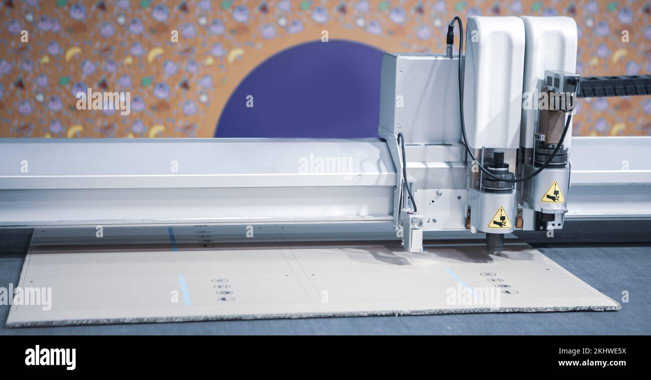 Digital die cut machine cutting corrugated cardboard. Industrial