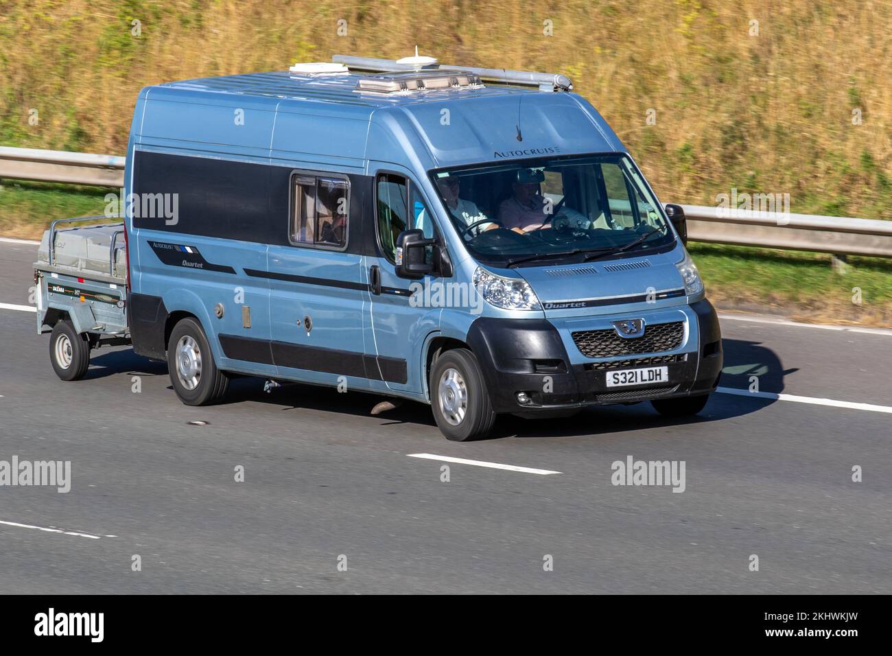 2012 Blue PEUGEOT BOXER HDI 335 ZUCKOFF TL 2198cc Diesel AutoCruis Quartet with camping trailer; travelling on the M6 motorway UK Stock Photo