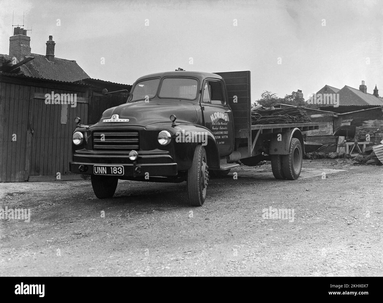An early 1960s black and white photograph showing Bedford Flat Bed Lorry, registration UNN 183, belonging to H. Dring Coal Merchants of Nottingham, England. Stock Photo