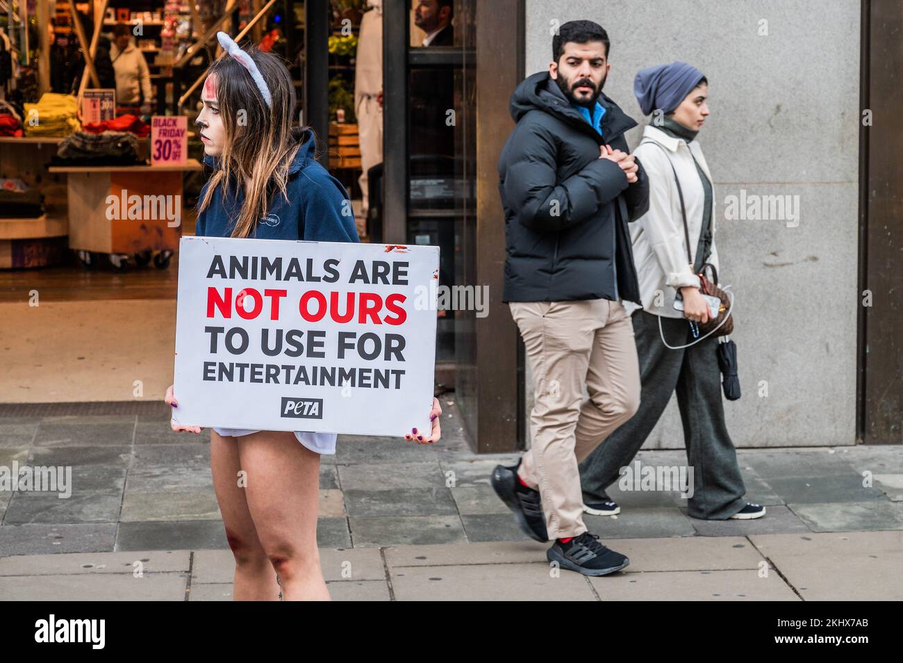 London, UK. 24th Nov, 2022. PETA supporter dressed as a “bloodied and