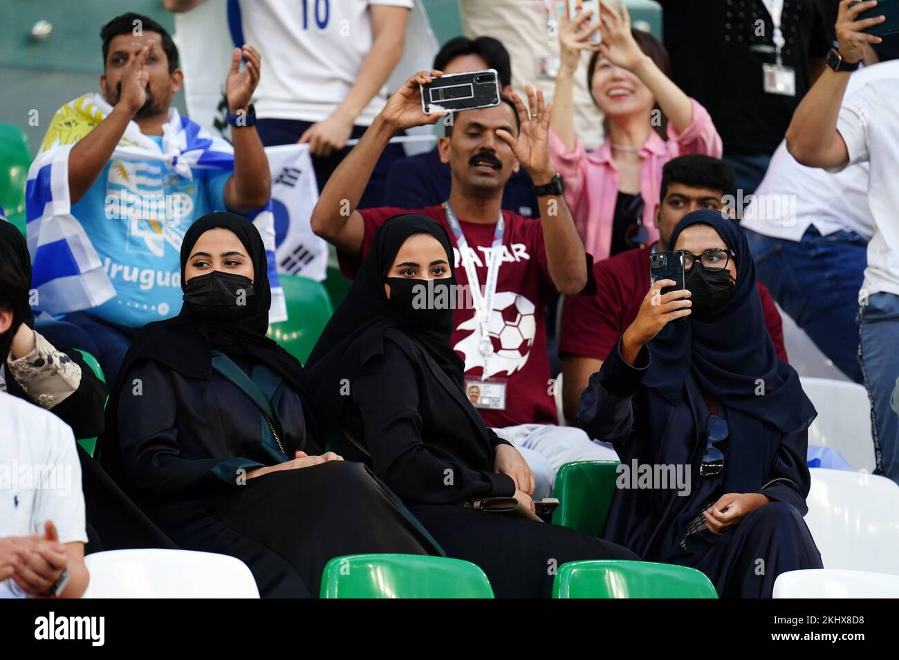 Qatari fans wearing an abaya as they watch from the stands during the FIFA World Cup Group H match at the Education City Stadium, Doha, Qatar. Picture date: Thursday November 24, 2022. Stock Photo