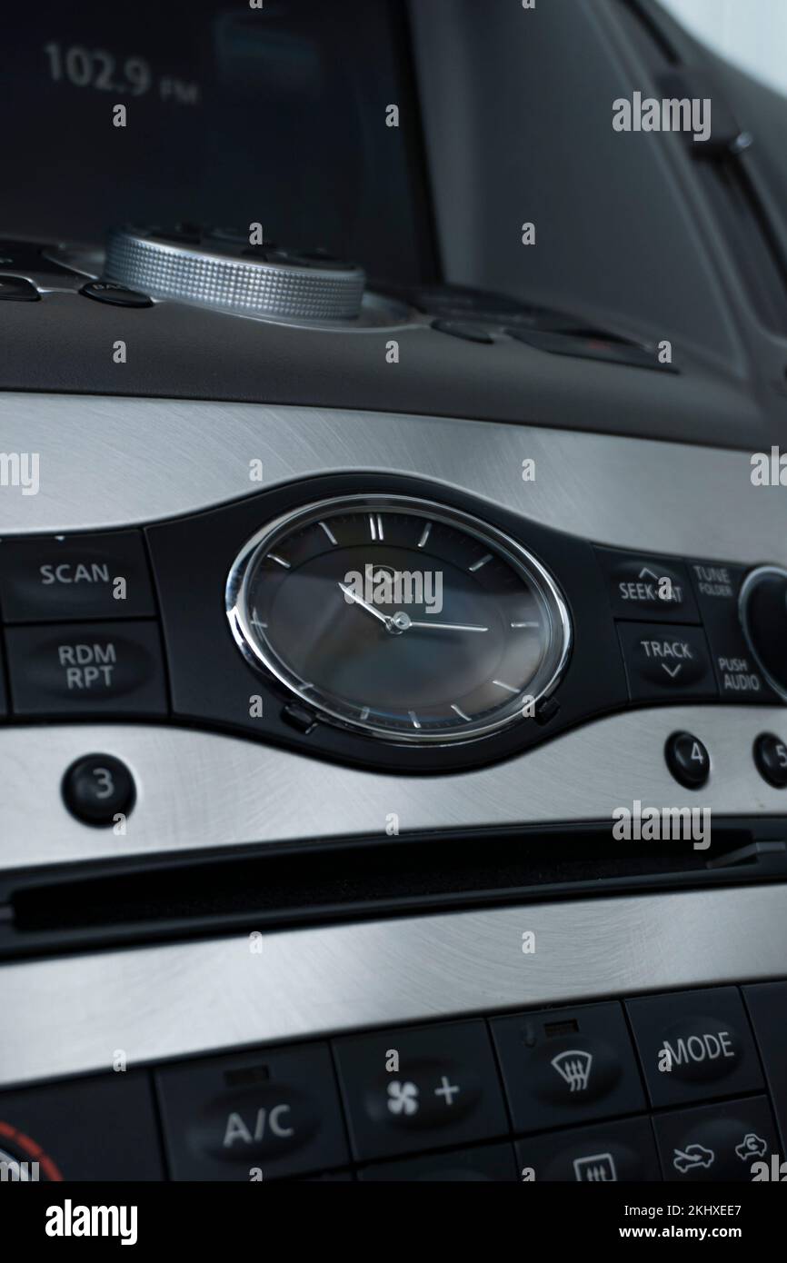 A vertical shot of Infinity G27 Dashboard analog clock Stock Photo Alamy