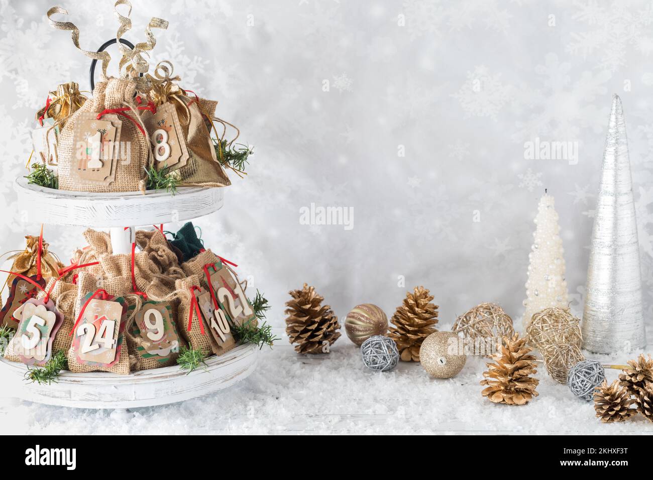 A homemade Advent calendar surrounded by festive decorations. Stock Photo