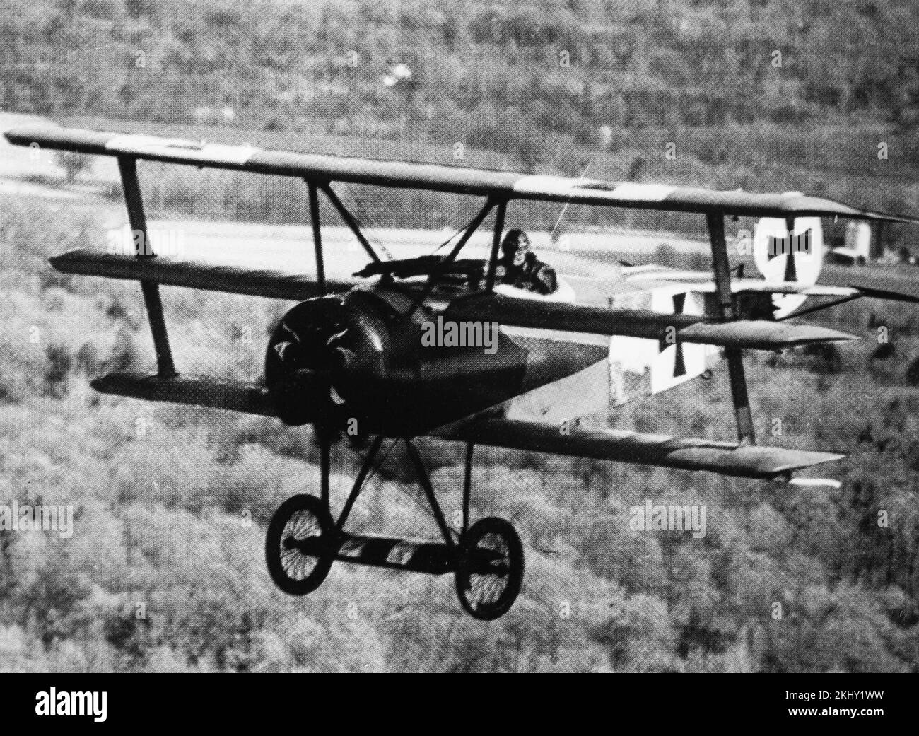 A vintage black and white photograph showing a Fokker DR.1 Triplane of the German Air Force Luftwaffe in flight. Stock Photo
