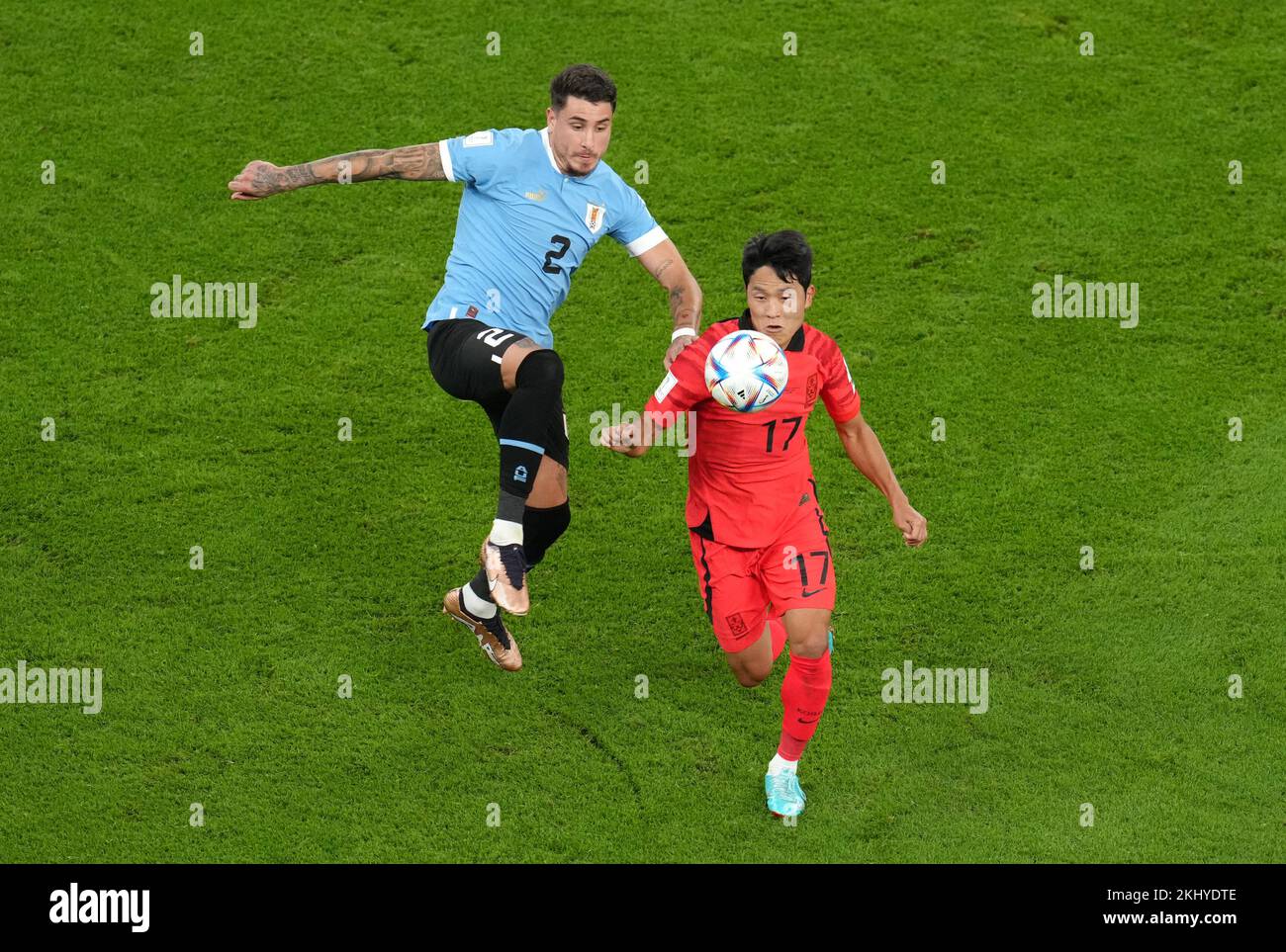 Uruguay's Jose Maria Gimenez (left) and South Korea's Na Sang-ho battle for the ball during the FIFA World Cup Group H match at the Education City Stadium, Doha, Qatar. Picture date: Thursday November 24, 2022. Stock Photo
